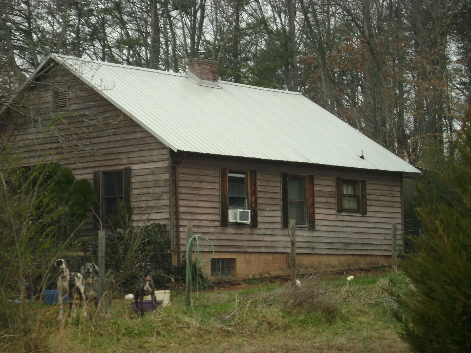 White metal roof on an old wood sided farmhouse, from a Metal Roof Installation job in Seaview